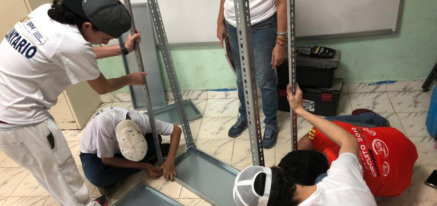 Voluntarios armando una estantería